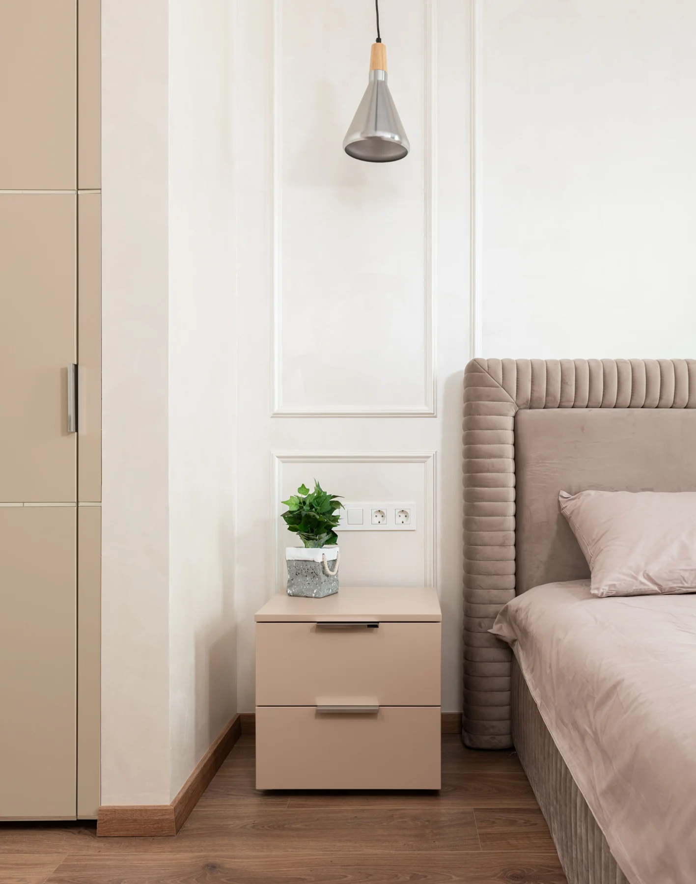 Bedroom with an upholstered bed and pendant lighting